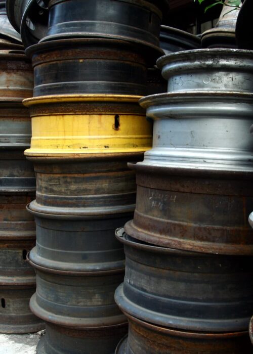 Used and surplus tire rims sold at a scrapyard